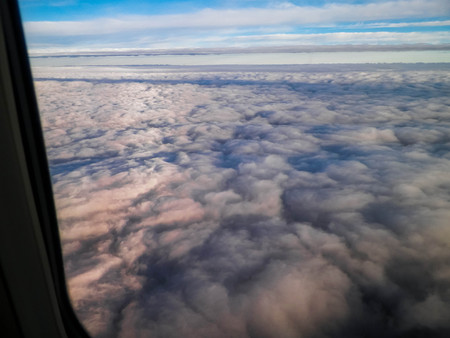 View from plane window on white clous. Travel and transport concept.の写真素材