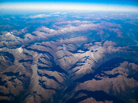 Horizon of the planet earth and Alps mountain tops. View from spaceship or plane.の写真素材