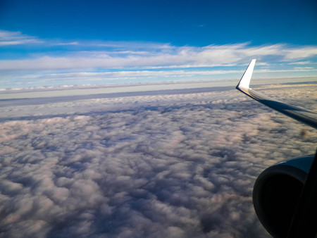 View of white clouds and plane enginie and wing. Transport concept. Copy space.の写真素材