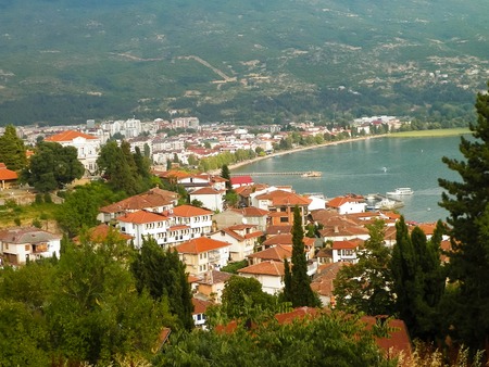 Coast of Lake Ochrid seen from Ochrid City. Ochrid is the oldest lake in Europe, known of its, clean, transparent water. Ohrid and Lake Ohrid are UNESCO natural and cultural heritage sites. Typical Macedonian architecture. Travel and Architecture concept.の写真素材