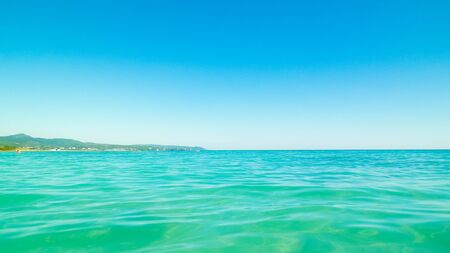 Sea coast in Vada, Tuscany, Italy. Mediterranean nature in summer day, blue, Tyrrhenian sea water on blue sky background. Vacations and nature concept. Copy space.の写真素材