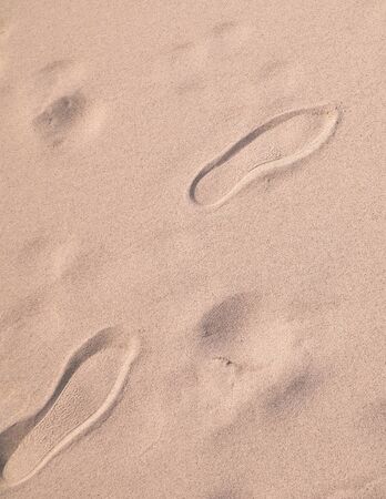 Shoe print on the sand. Copy Space, nature background.