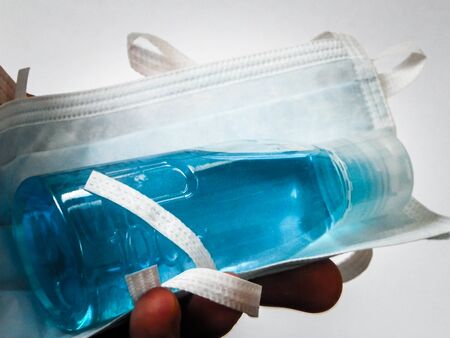 Antibacterial fluid and mask. Coronavirus protection kit. Hygiene is very important to avoid infection of voronavirus.の写真素材