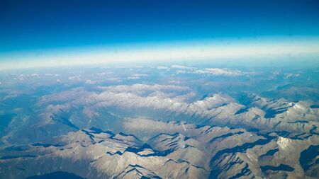 Horizon of the planet earth and Alps mountain tops. View from spaceship or plane.の写真素材