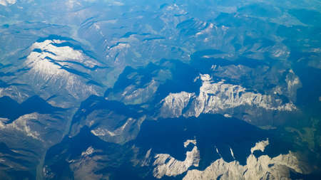 Alps, view of the mountains from the window of the plane. Land bending and nature concept.の写真素材