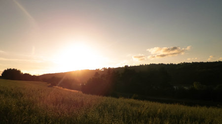 Sunset sky over fields and meadows. Kashubia, Pomerania, Poland.の写真素材