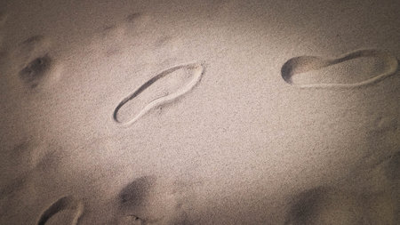 Shoe print on the sand. Copy Space, nature background.