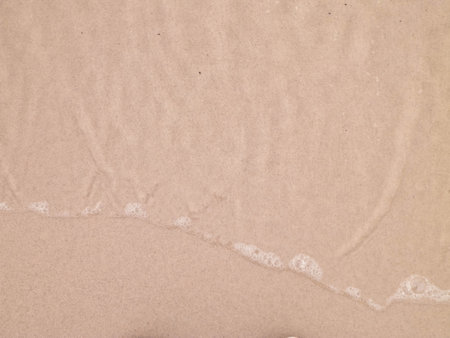 Sea water on sandy beach sand - nature background. Copy space, holidays concept.