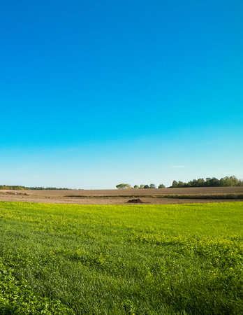 Blue sky over fields and meadows. Springtime in Kashubia. Poland. Copy space on blue sky.の写真素材