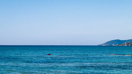 Coast in Italy in Vada, Tyrrhenian sea water on blue sky background. Vacations and nature concept. Copy space.の写真素材