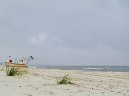 Boat on baltic sea shore in winter. Krynica, Piaski close to the Russian border Polandの写真素材