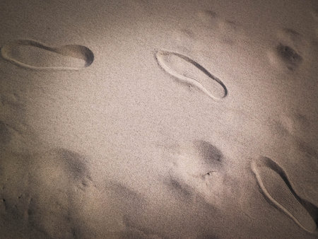 Shoe print on the sand. Copy Space, nature background.