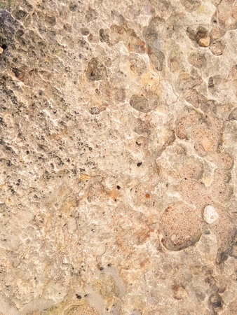 Coastal rocks and sea water as a natural background. Copy space.