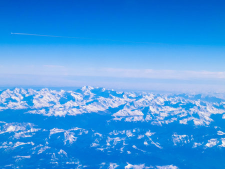 Beautiful view of Alps mountains from the plane window. Travel concept.