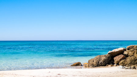 Stones on the beach in Vada, transparent, turquoise water and white sand. Travel and nature concept.の写真素材
