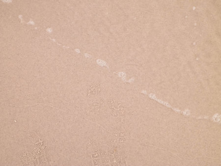 Sea water on sandy beach sand - nature background. Copy space, vacations concept.の写真素材