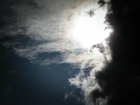 Sun hiding behind the clouds. Weather concept.の写真素材