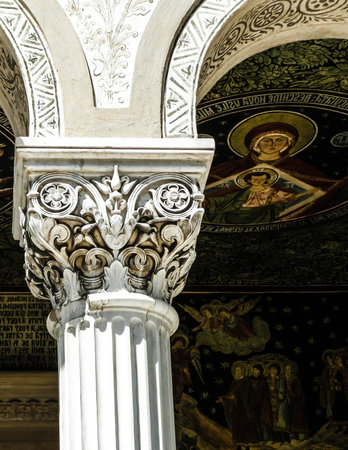 Column and religious paintings in Saint Peter and Saint Paul the Apostles Cathedral, Constanta, Romagna. Art, architecture and religion concept.の写真素材