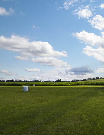 Harvest bales on a green field. End of the summer in northern Poland. Harvesting.の写真素材
