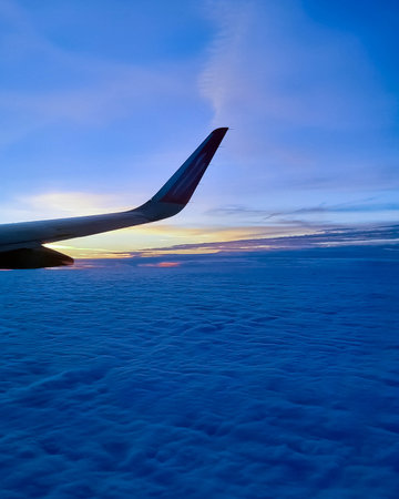 Plane travel at sunrise or sunset. Beauty of nature view from plane window.