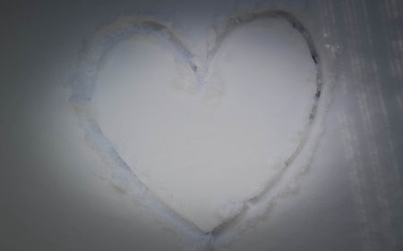 Heart carved in the snow. Copy space. Valentines concept.の写真素材