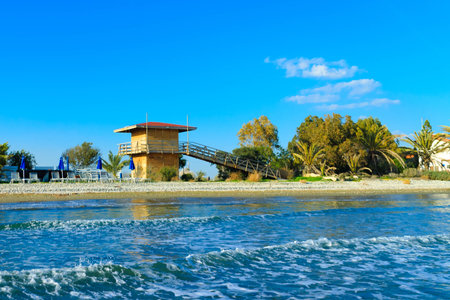 Touristic area on beach near Perivolia on Cyprus. Lifeguard tower on coast.の写真素材