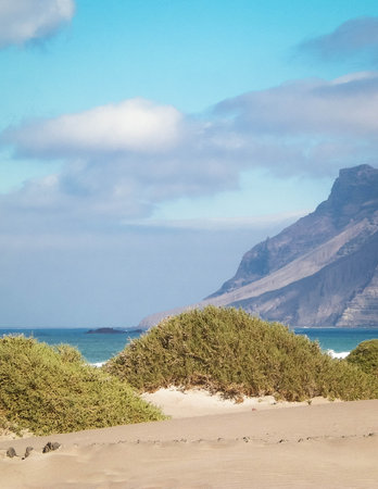 Sandy beach Caleta de Famara on the island of Lanzarote. Canaries. An iconic place among surfers.の写真素材