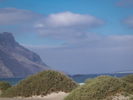Sandy beach Caleta de Famara on the island of Lanzarote. Canaries. An iconic place among surfers.の写真素材