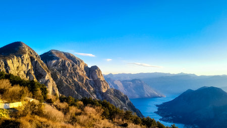 Sunny day over Lovocen Mountain tops and Kotor Bay fjords. The Lovcen Mountains lie around Boka Kotorska in Montenegro. Kotorska bay in a foreground.の写真素材