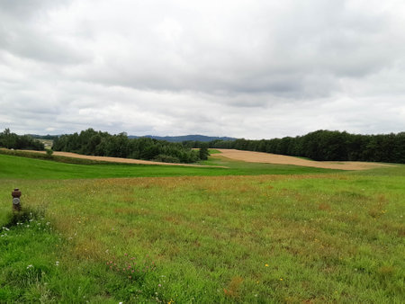 Dark clouds over field in Kashubia. Incoming storm. Amazing nature of northern Poland.の写真素材