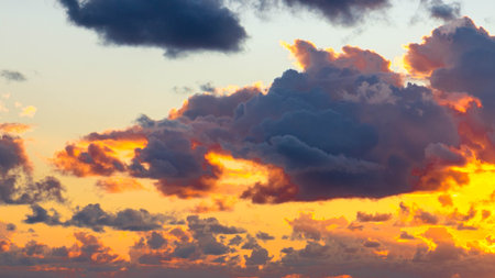 Amazing sunset or sunrise sky. Clouds in light of sun. Stunning view.の写真素材