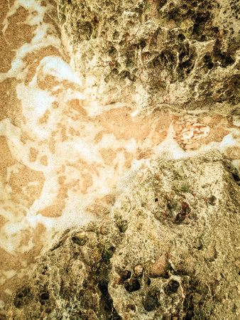 Coastal rocks and sea water as a natural background. Copy space.