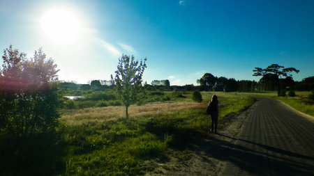 Offroad in Kashubian village. Kashubia is part of northern Poland, known of it's beautiful nature. Lonely person traveling across village road, summer season, beautiful Polish environment.の写真素材