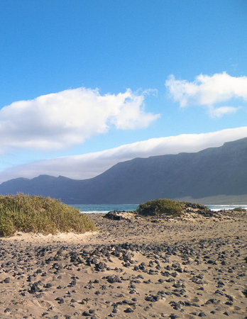 Beach in Caleta de Famara. Lanzarote Island. Canary Islands archipelago. Popular place for surfing.の写真素材