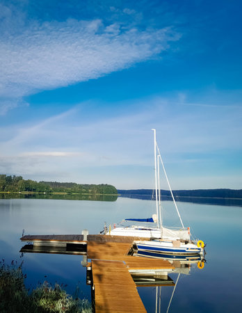 Boat in marina on lake at sunny day. Beautiful nature of Kashubia.の写真素材