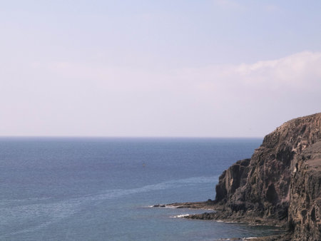 Seascape of Lanzarote island cliffs. Rocky coast, nature concept.の写真素材