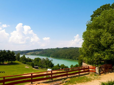 Rural landscape of Wiezyca region in Kashubia, Poland. Pastures, meadows and Ostrzyckie lake in background.の写真素材