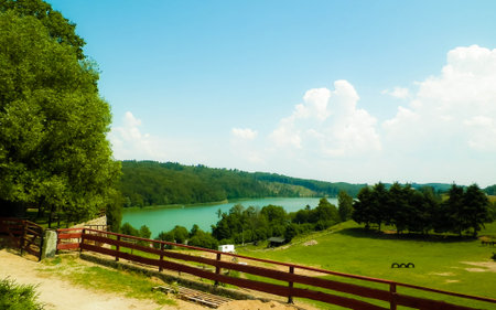 Rural landscape of Wiezyca region in Kashubia, Poland. Pastures, meadows and Ostrzyckie lake in background.の写真素材