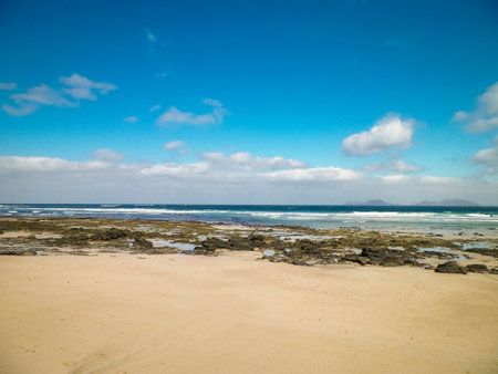 Sandy beach Caleta de Famara on the island of Lanzarote. Canaries. An iconic place among surfers.