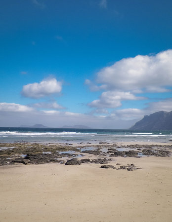 Sandy beach Caleta de Famara on the island of Lanzarote. Canaries. An iconic place among surfers.の写真素材