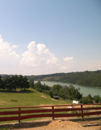 Rural landscape of Wiezyca region in Kashubia, Poland. Pastures, meadows and Ostrzyckie lake in background.の写真素材