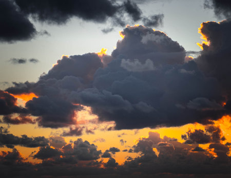 Amazing sunset or sunrise sky. Clouds in light of sun. Stunning view.の写真素材
