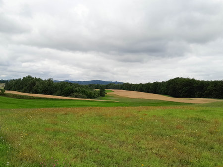 Dark clouds over field in Kashubia. Incoming storm. Amazing nature of northern Poland.の写真素材