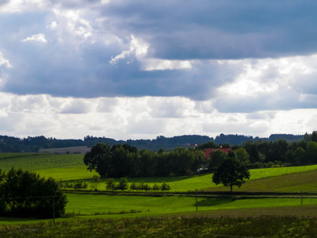 Rainy day over green hills and meadows of Kashubian Region, Poland. Copy space on cloudy sky.の写真素材