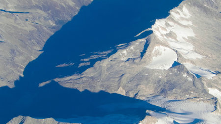 Alps, view of the mountains from the window of the plane. Land bending and nature concept.の写真素材