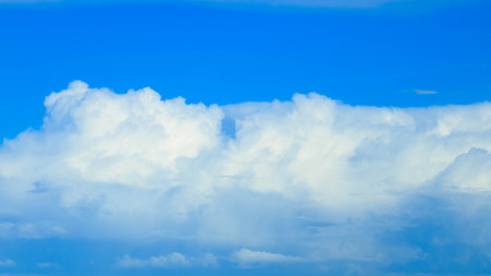 Dark clouds on blue sky. Incoming rain. Weather changing concept.の写真素材