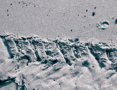 Tire track on sand of desert or beach. Natural background. Offroad and traveling concept.の写真素材