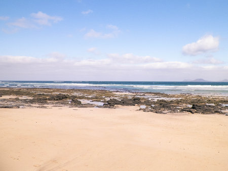 Sandy beach Caleta de Famara on the island of Lanzarote. Canaries. An iconic place among surfers.の写真素材