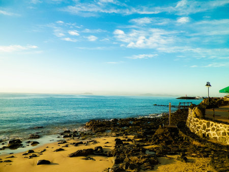 Canarian coast, beach, rocks, and Atlantic Ocean in Playa Blanca. Typical coast of Lanzarote island. Vacations and tourism concept.の写真素材