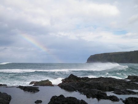Rainbow over the Atlantic Ocean. Sao Miguel island coast. Azores.の写真素材